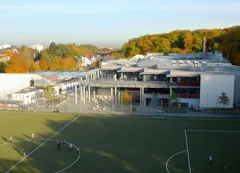 Frankfurt International School main campus in Oberursel, viewed across the sports field.